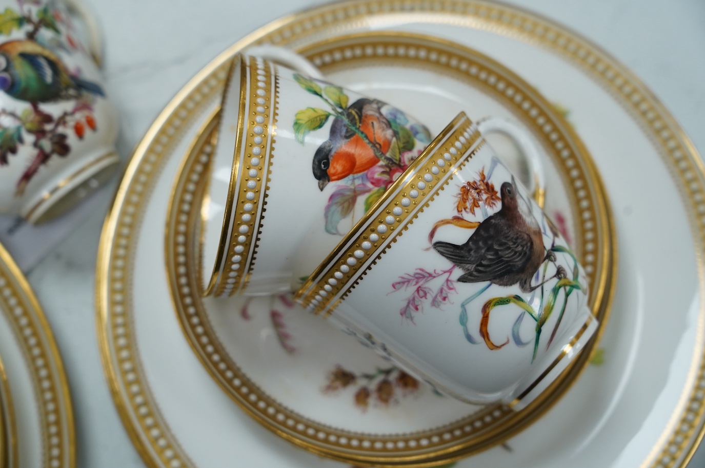 A 19th century Royal Worcester ornithologically decorated part tea set, with gilt and jewelled edges, six place setting. Condition - good